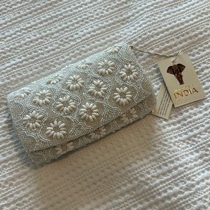 White beaded clutch with tags